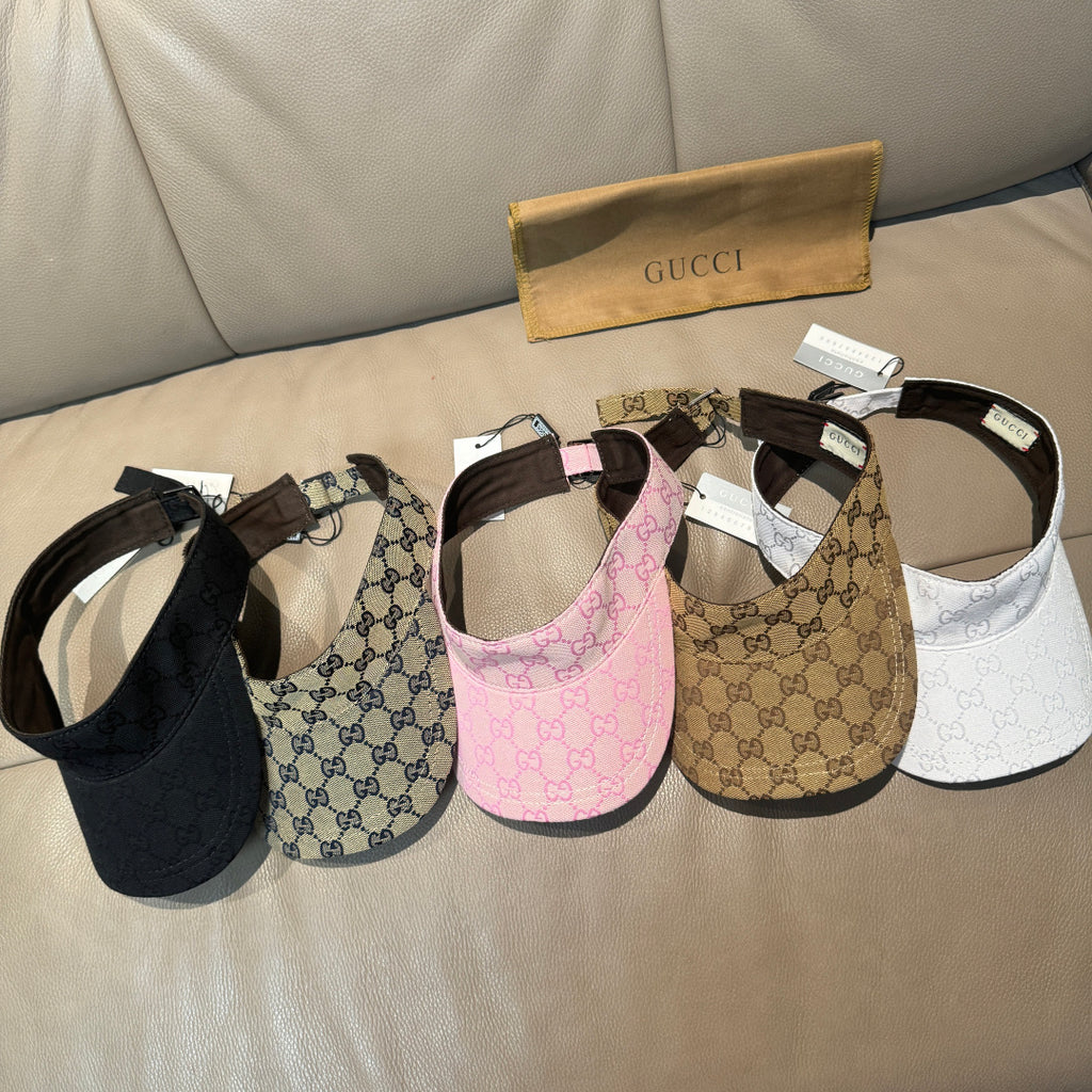 Assorted monogram visor caps: black, beige, pink, and white with adjustable straps