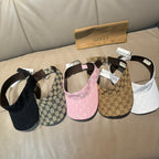 Assorted monogram visor caps: black, beige, pink, and white with adjustable straps