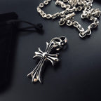 Silver cross pendant necklace detail with linked chain and clasp loop