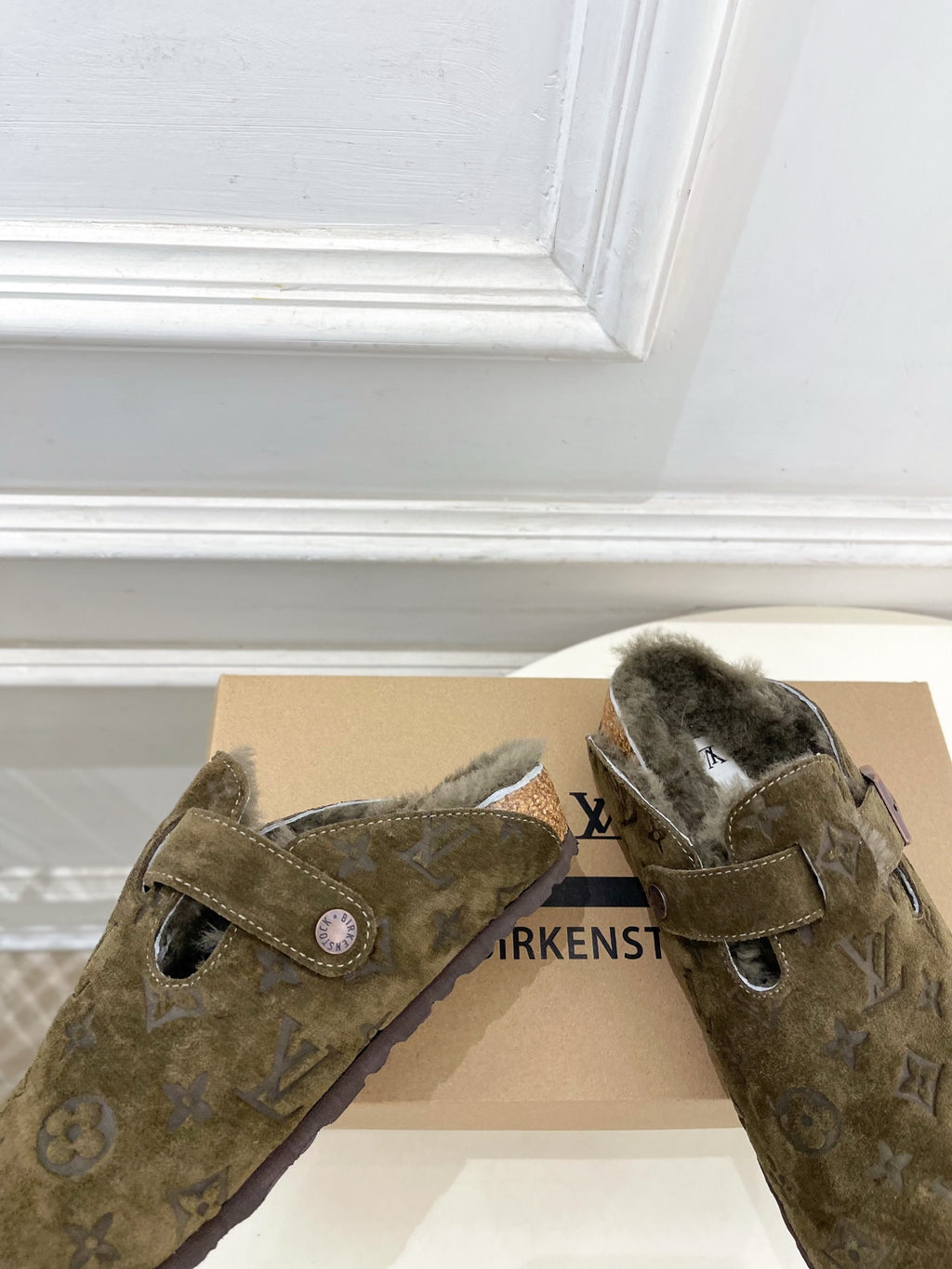 Olive green monogram sandals with shearling lining and two adjustable buckle straps