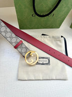 Gucci GG canvas belt with gold G buckle and red leather strap