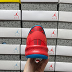Red sneaker heel and toe with blue midsole and textured outsole.