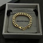 Balenciaga chain bracelet in gold tone with black ties and BALENCIAGA center tag