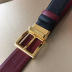 Prada belt buckle close-up, gold frame with burgundy leather lining