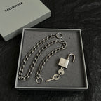 Silver-tone chain bracelet with padlock and key charm, laid in a gift box