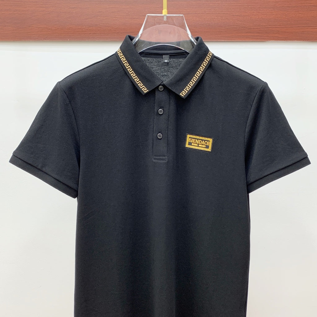 Versace black polo shirt with button placket, gold trim collar, logo patch
