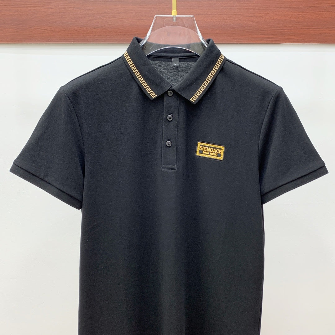 Versace black polo shirt with button placket, gold trim collar, logo patch