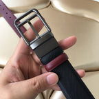 Belt with dark blue webbing, burgundy leather trim, and silver-tone buckle frame
