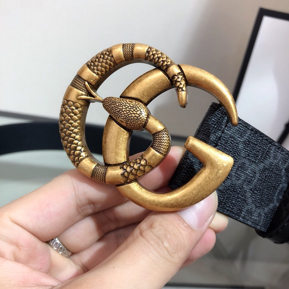 Gucci belt close-up: gold double-G buckle with textured detailing on dark strap