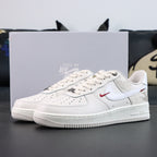 White Air Force 1 low sneakers with red swoosh and perforated toe