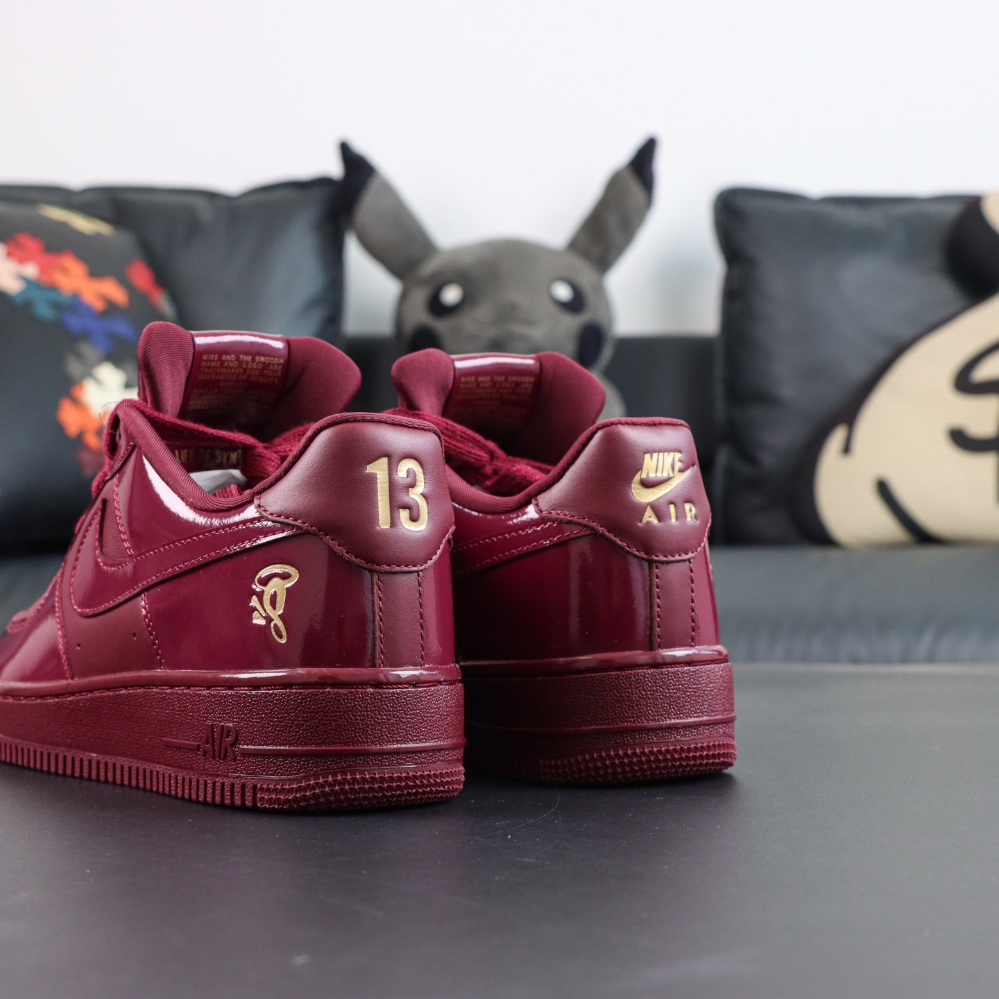 Burgundy low-top sneakers, heel and tongue view with '13' and Nike Air branding
