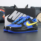 Nike Air Force 1 low-top sneakers, blue and black with yellow Swoosh; front view.