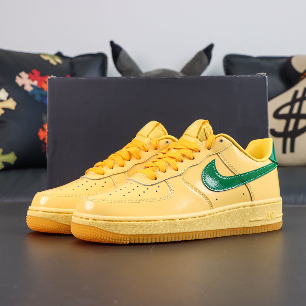 Nike Air Force 1 sneakers, yellow with green swoosh, lace-up front view