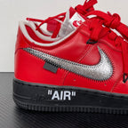 Red low-top sneakers with silver Nike swoosh, black sole, red laces