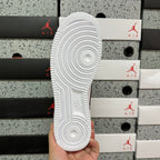 White sneaker outsole with circular tread pattern, underside view