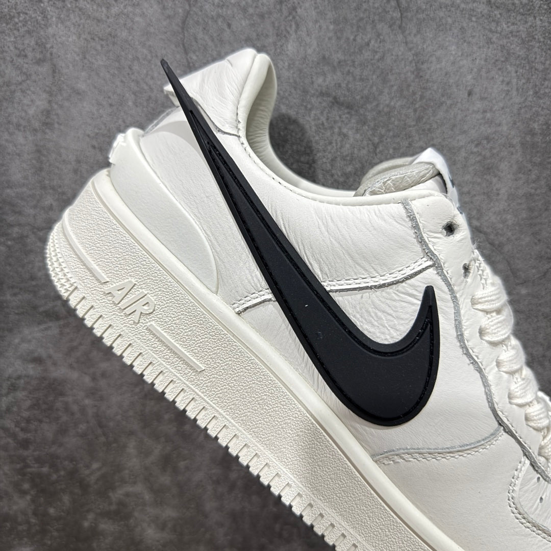 White leather sneaker side view with black swoosh and chunky off-white midsole