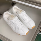 Pair of Amiri white leather sneakers with star motif and white laces on gum soles