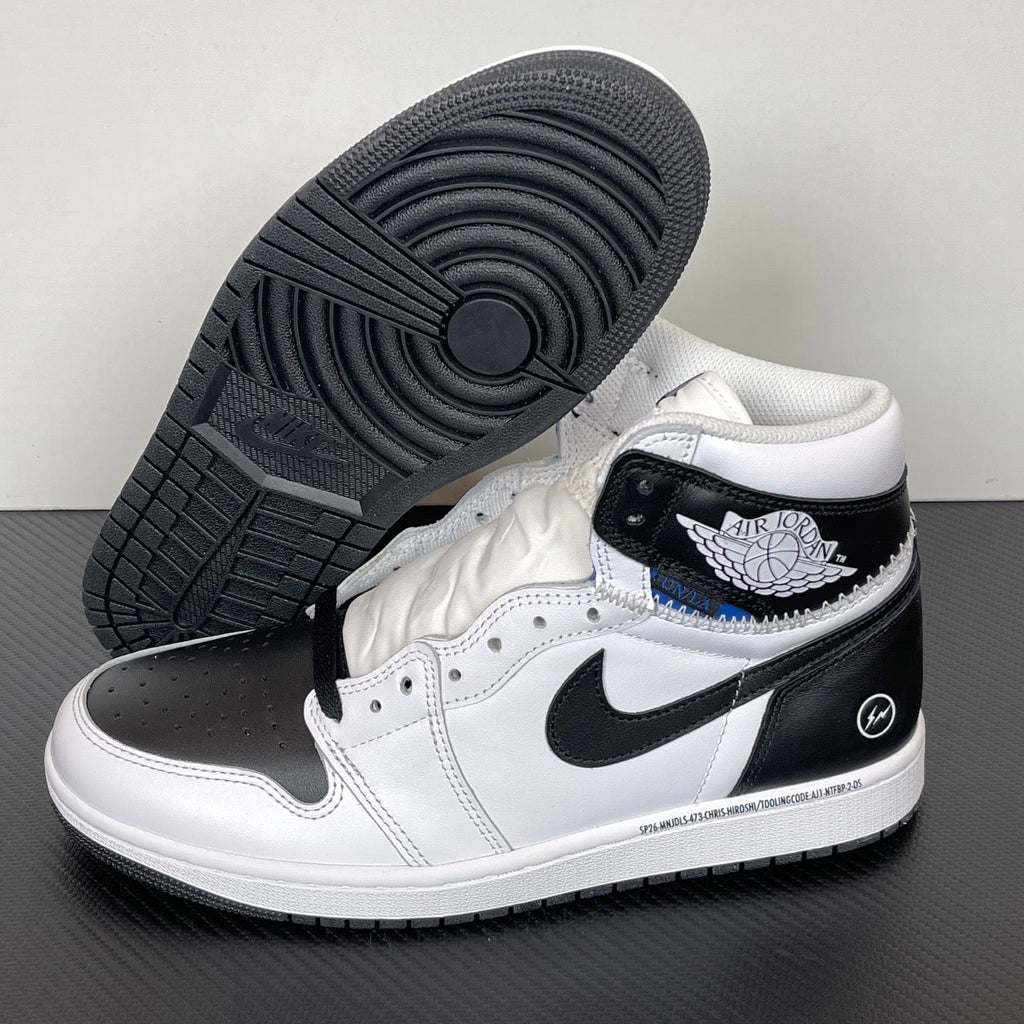 White and black high-top sneakers with black outsole tread and blue accent near collar