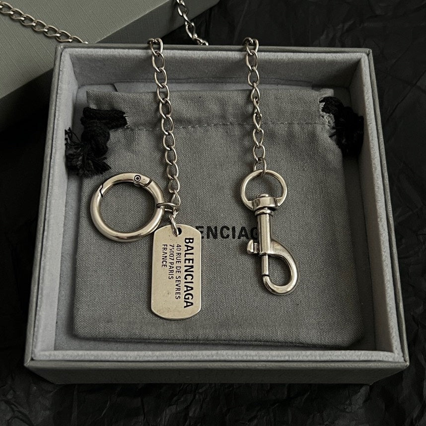 Balenciaga keychain set with metal rings and dog tags in gray-lined box