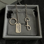 Balenciaga keychain set with metal rings and dog tags in gray-lined box