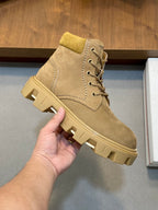 Suede lace-up ankle boot with side stitching and thick ridged rubber sole.