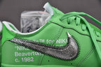 Green sneaker heel with metallic swoosh detail and white lace collar