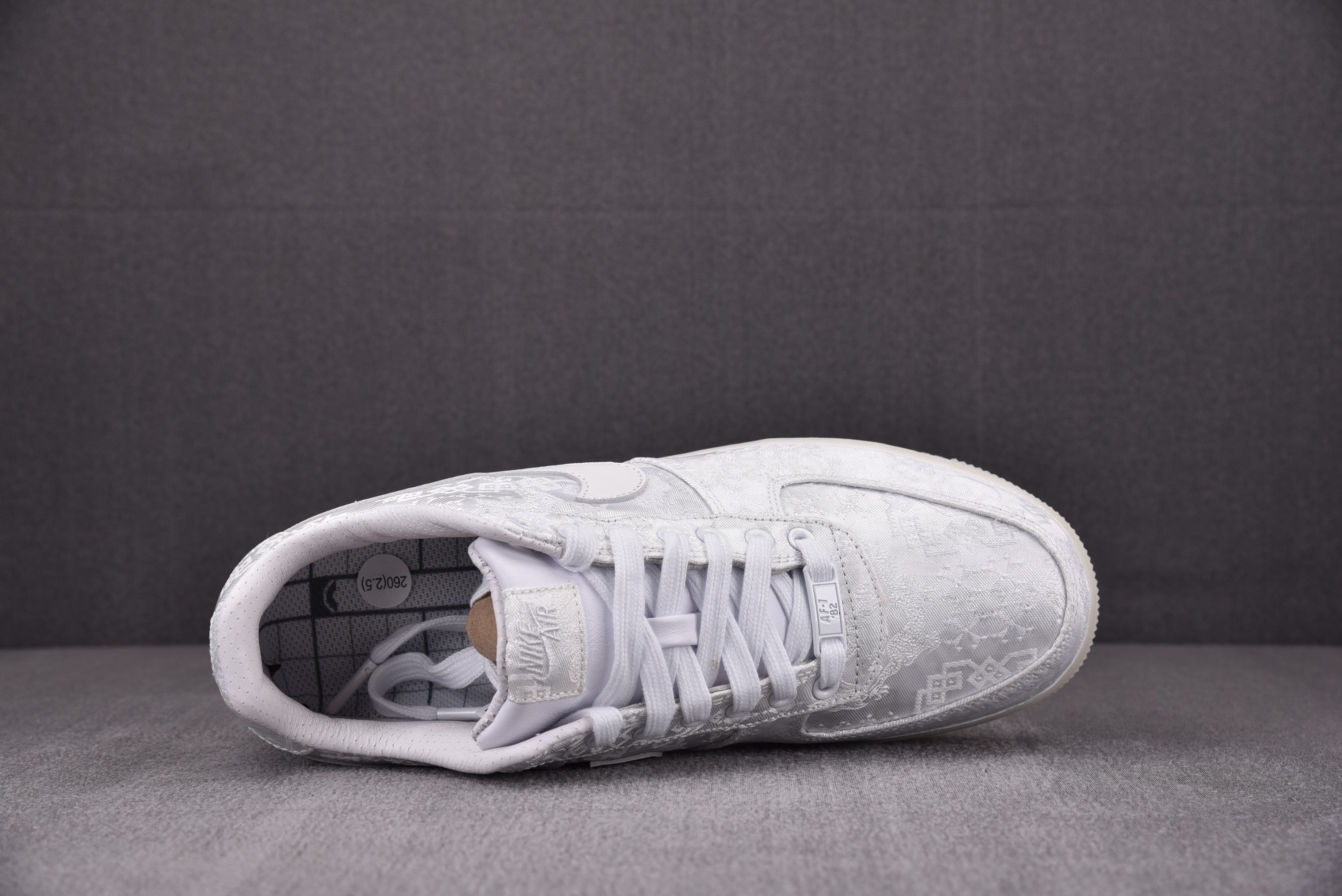White low-top sneakers, open toe view showing white laces and lining