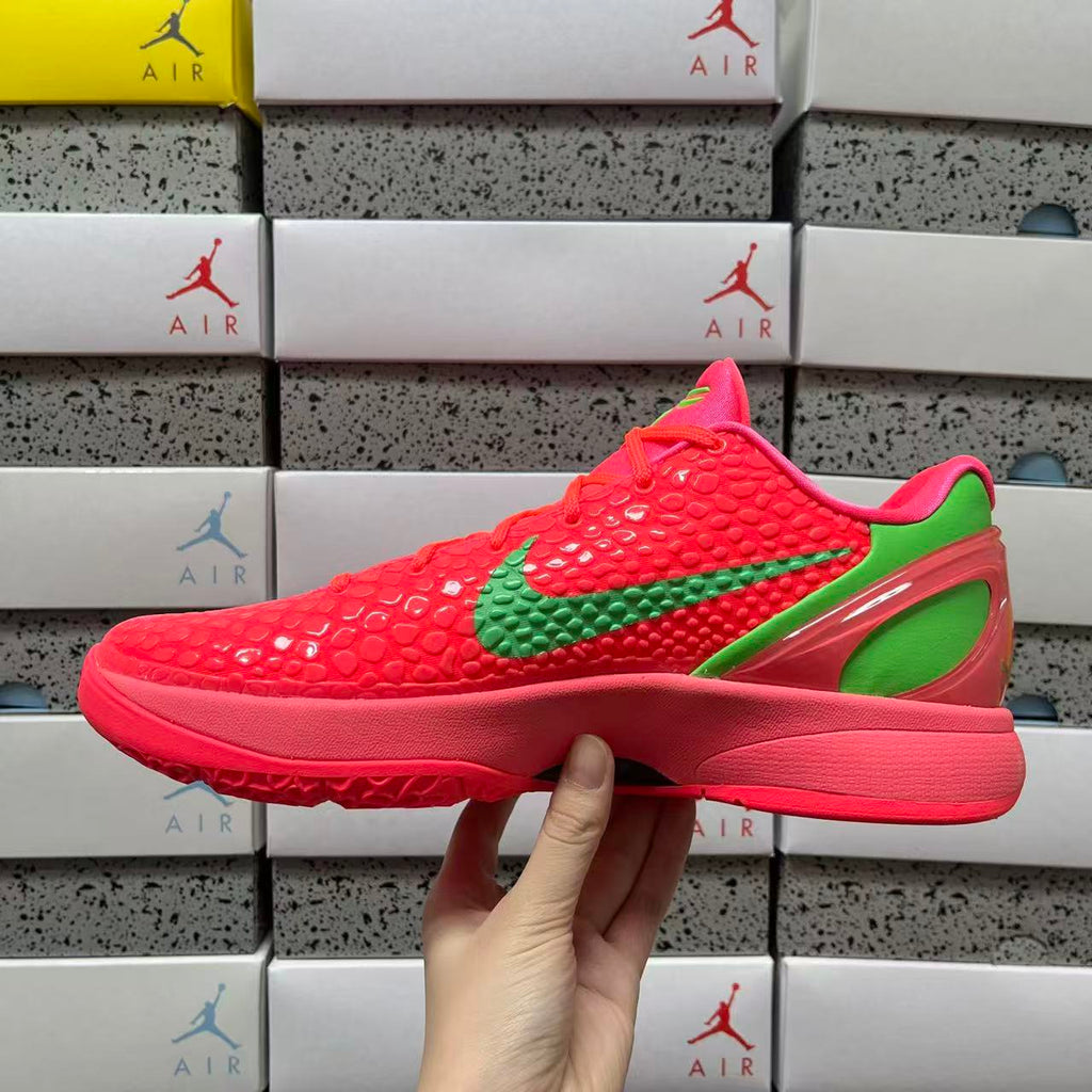 Red low-top sneaker profile with green swoosh and bold sole, side view