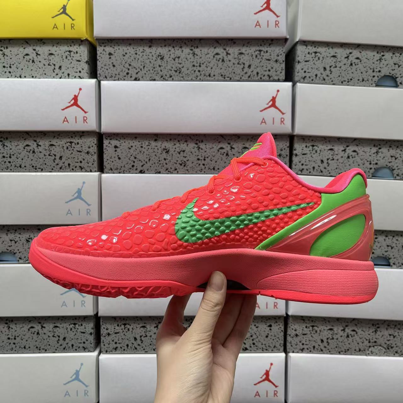 Red low-top sneaker profile with green swoosh and bold sole, side view