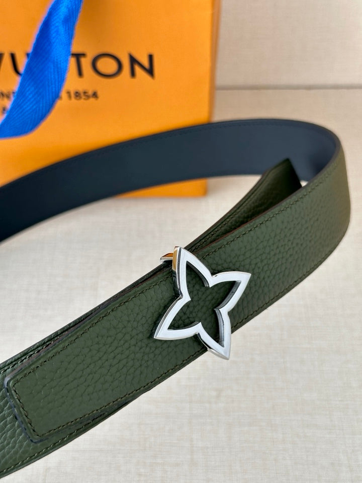 Green leather belt close-up with silver star buckle and edge stitching