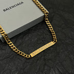 Balenciaga gold-tone curb chain necklace with rectangular logo plate