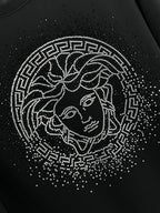 Black crewneck sweatshirt with rhinestone Medusa face graphic