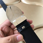 Prada belt buckle underside with silver clasp and dark leather keeper