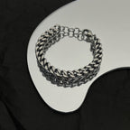 Silver chain bracelet with interlocking links and round ring clasp, close-up