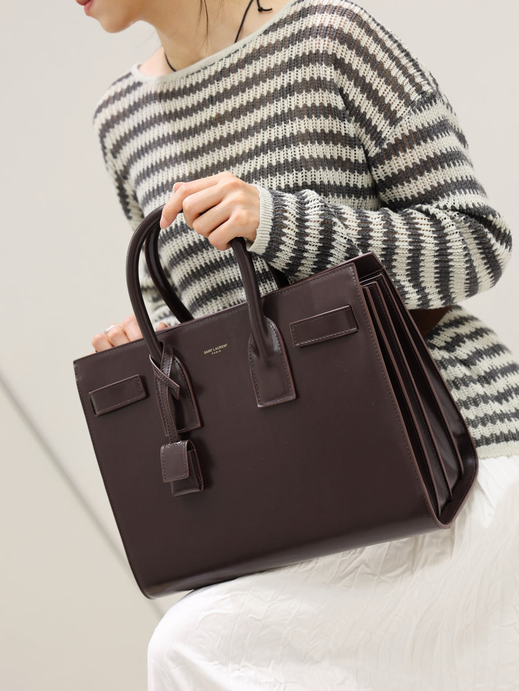 YSL structured leather tote bag with top handles and front flap, dark brown.