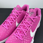 Close-up of pink lace-up sneakers with textured upper and white midsole
