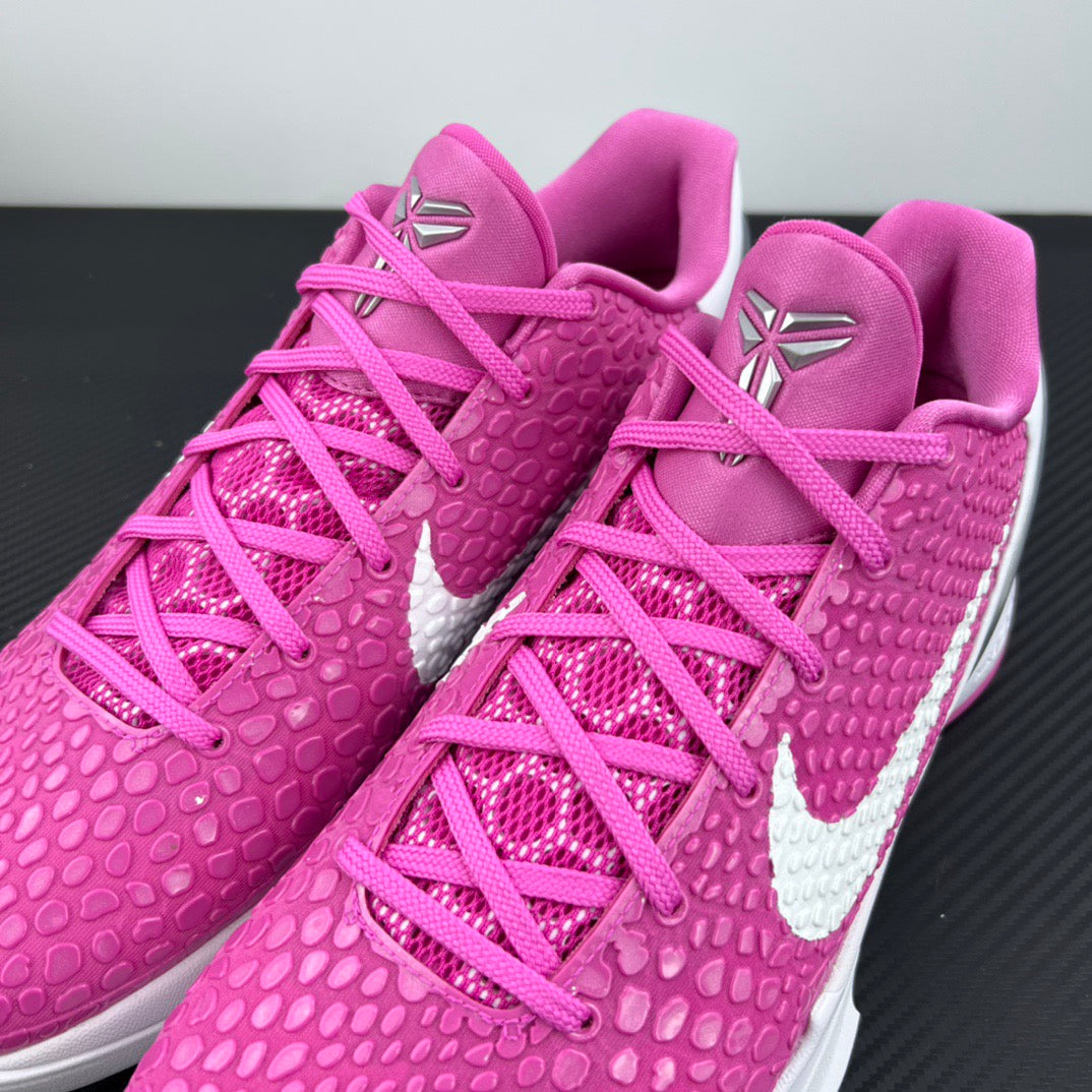 Close-up of pink lace-up sneakers with textured upper and white midsole