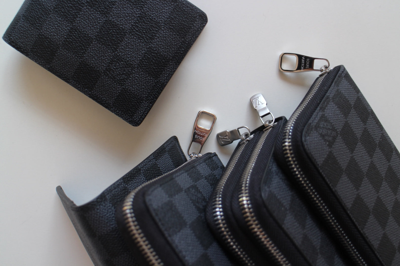Louis Vuitton small zip pouches, dark checker pattern with silver zippers