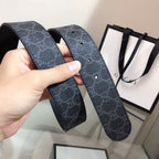 Gucci belt straps laid out with dark monogram texture and prong holes