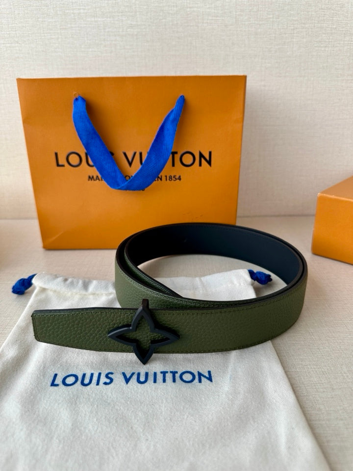 Green leather belt with silver star buckle, laid flat on fabric