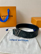 Louis Vuitton belt coiled with dark blue monogram strap and LV rhinestone buckle