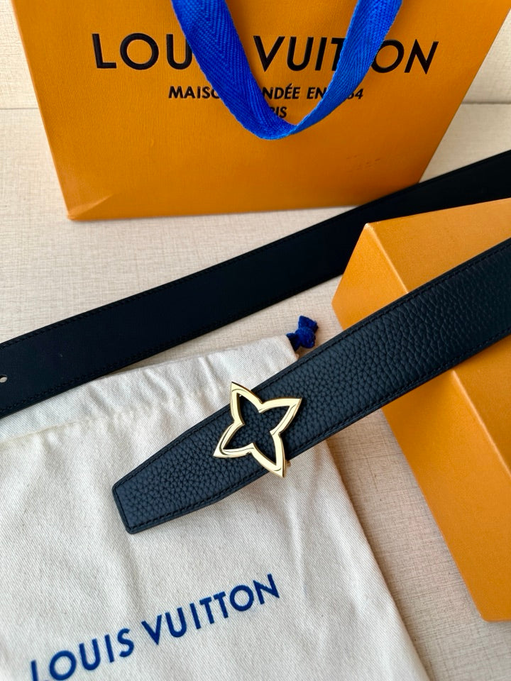 Navy leather belt with star emblem buckle, belt strap laid over tissue