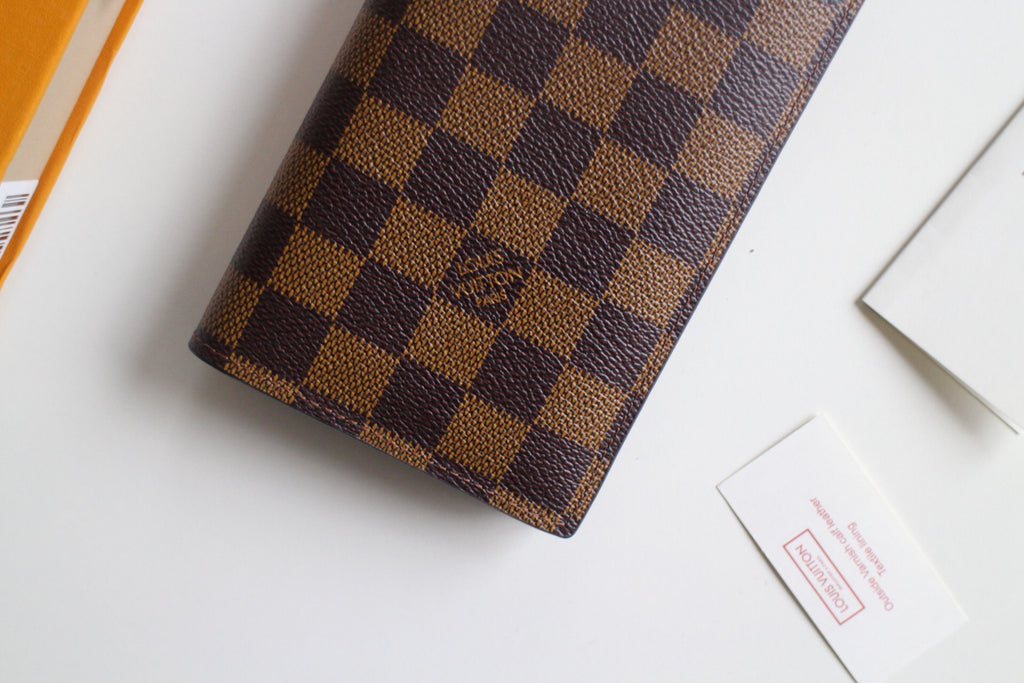 Louis Vuitton small checkered wallet close-up, dark brown and tan check pattern