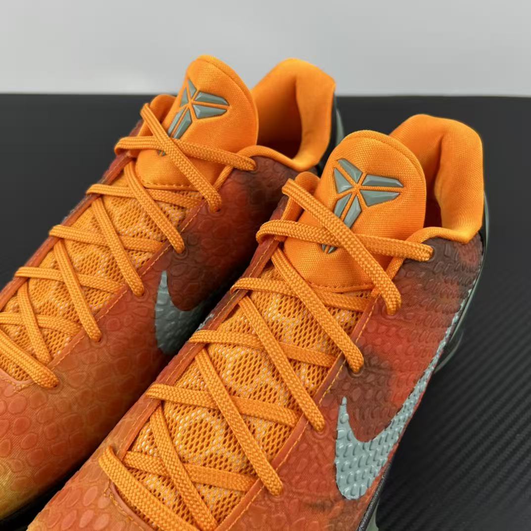 Basketball shoes with orange laces and orange-to-brown gradient upper