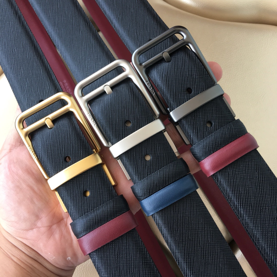 Pair of belts: dark blue webbing with burgundy leather, silver-tone buckles