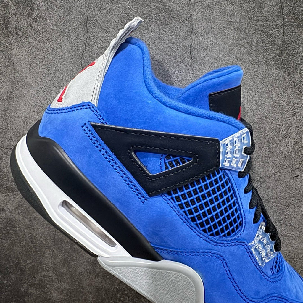 Air Jordan 4 sneakers side view in blue suede with black trim, clear lace piece, white air unit