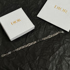 Silver-tone DIOR chain bracelet laid flat, alternating oval and bar links