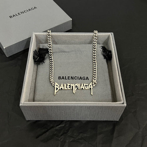Balenciaga logo necklace with silver-tone chain and dangling charm in box