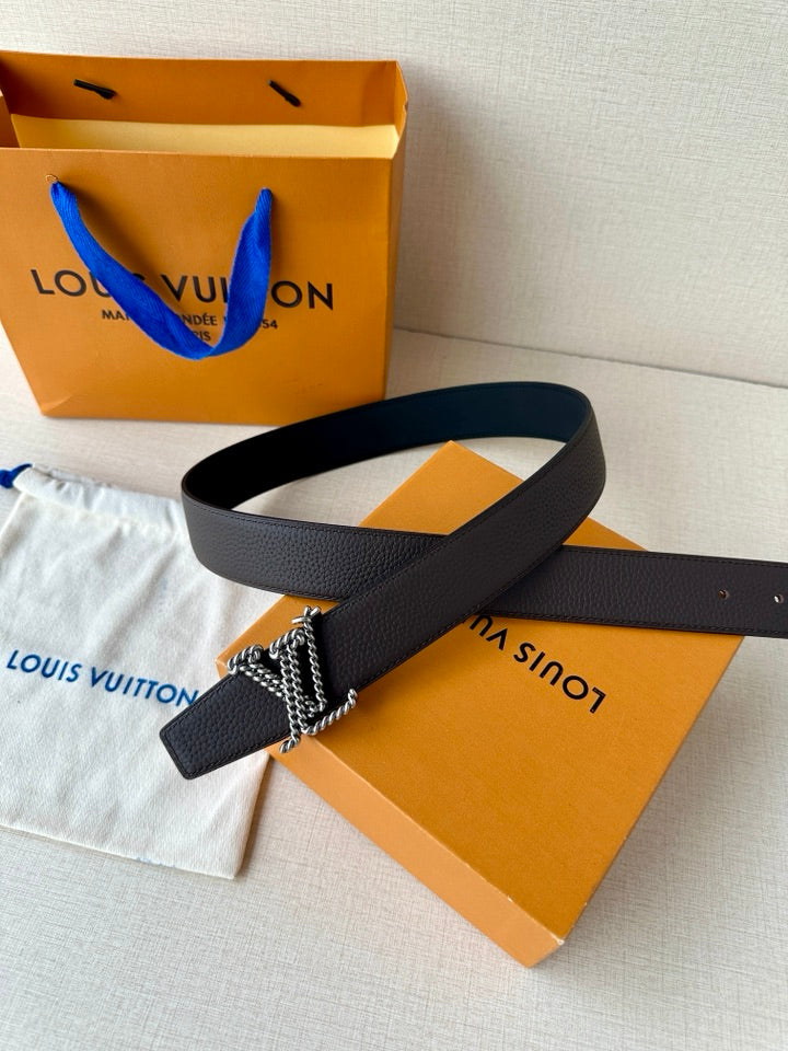 Louis Vuitton belt with dark leather strap and metallic chain buckle accent