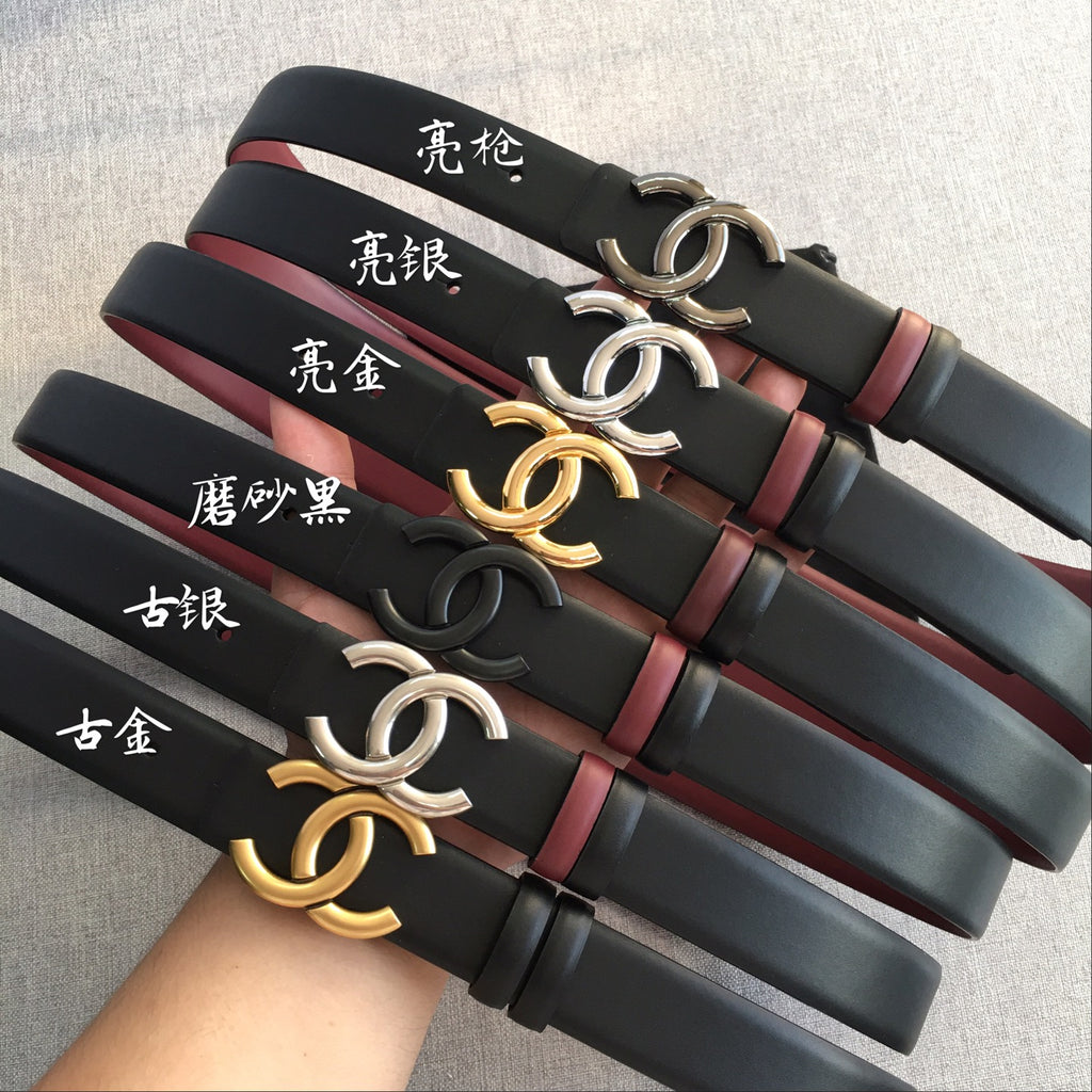 Chanel belt assortment with black straps, burgundy trim, and double-C buckles in silver, gold
